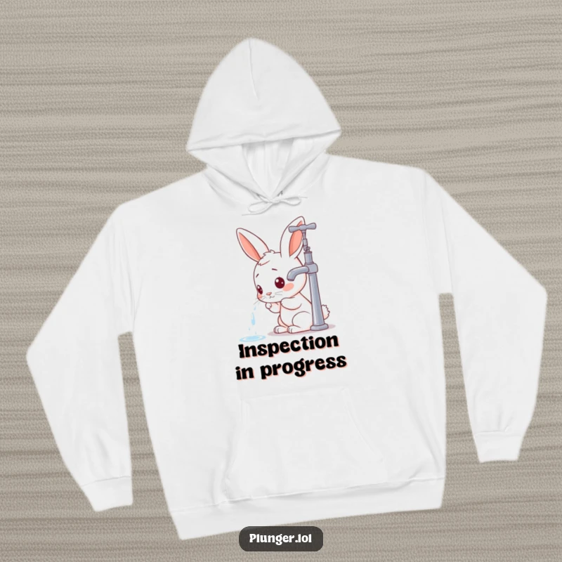 Funny rabbit character focused on inspecting a faucet, creating a warm and humorous graphic for a cozy hoodie.